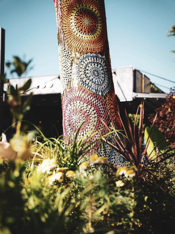 Crocheted tree canopy outside Torelli Lounge